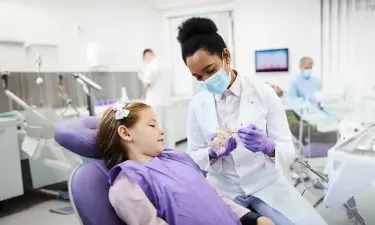 Dental hygienist who bridged from associate to bachelor's dental hygienist degree showing patient tooth structure