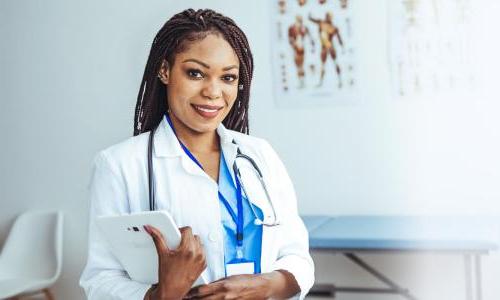 Women's health nurse practitioner smiling in clinic 